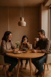 Matrimonio y su hija de 7 años disfrutando de la merienda de la tarde en su mesa de comedor